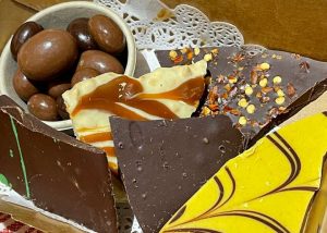 A box filled with delectable chocolates and caramels, perfect for sunshine coast day trips and sunshine coast wine tours.
