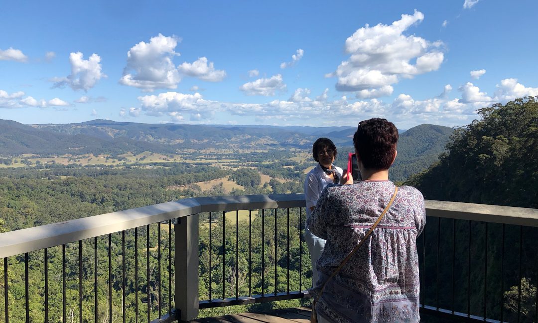 A couple taking a photo at one of the scenic lookouts on our Sunshine Coast Winery tour.