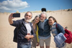 A group of people taking a selfie on the beach during a sunshine coast day trip.
